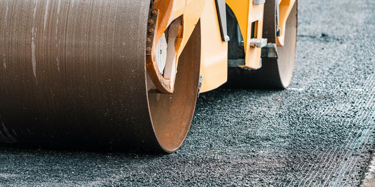 Image commercially licensed from: https://unsplash.com/photos/the-roller-paver-levels-the-asphalt-during-the-construction-of-the-highway-road-6E8Rn_qRrMw