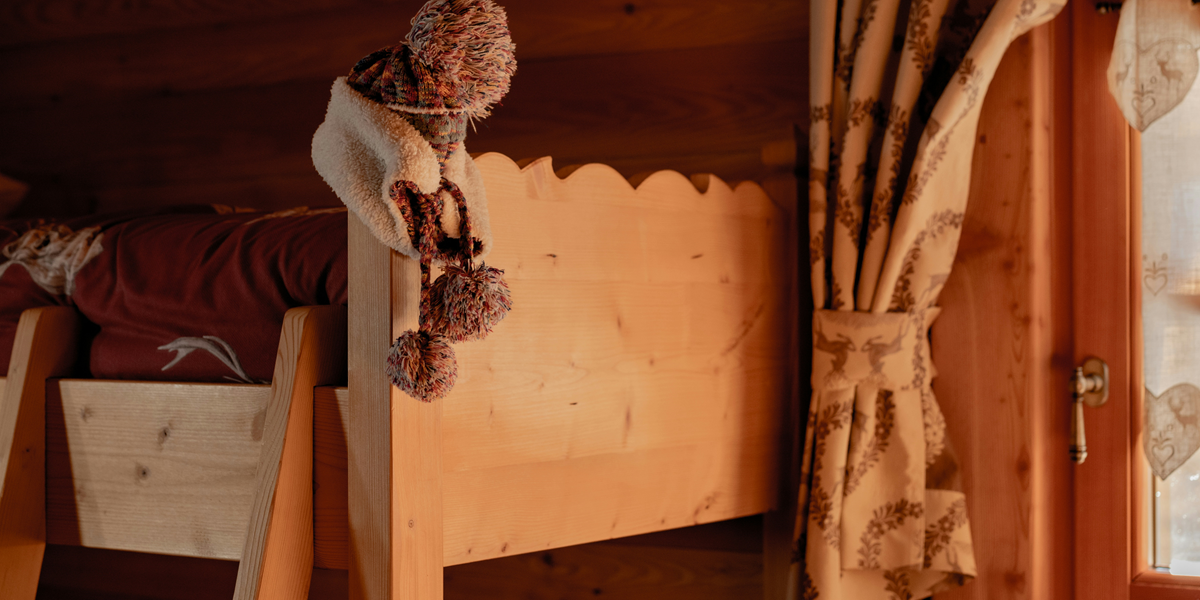 Image commercially licensed from: https://unsplash.com/photos/a-wooden-bunk-bed-with-a-scarf-on-top-of-it-cxFlUXWlQeA