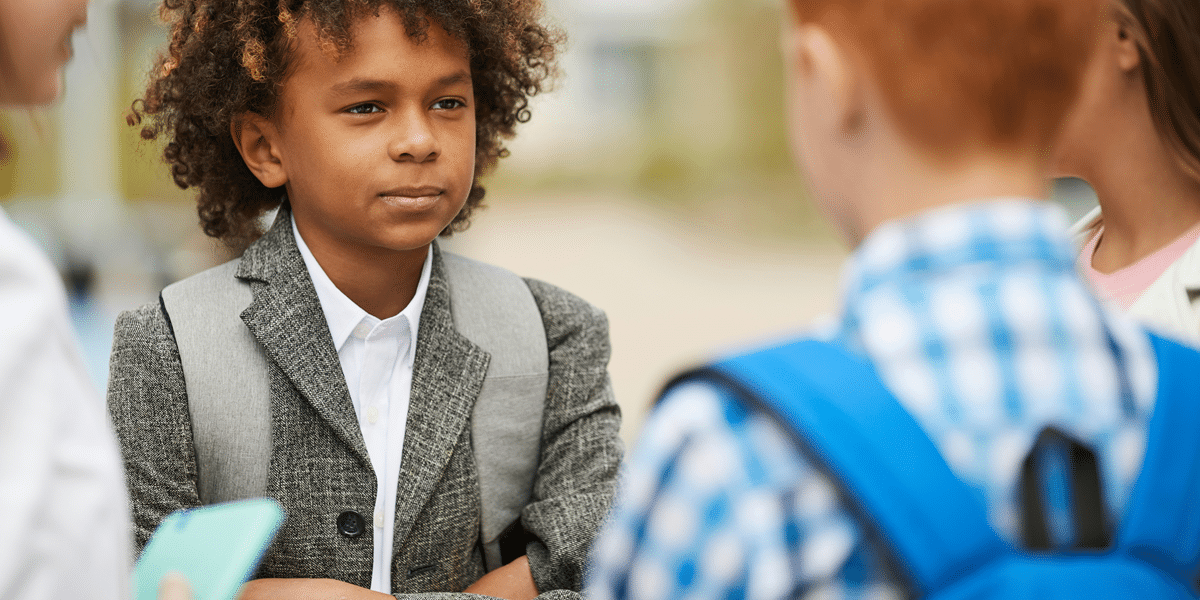 Image commercially licensed from: https://unsplash.com/photos/african-schoolboy-with-curly-hair-standing-and-talking-to-his-friends-outdoors-after-school-lessons-wPuMjaWF_Kc
