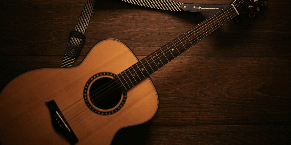 Image commercially licensed from: https://unsplash.com/photos/brown-acoustic-guitar-on-brown-wooden-floor-b57RqS-nQ1c
